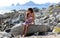 Little girl sitting at rocks at ocean front in Los Cabos Mexico resort cliff sea