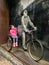 Little girl sitting on a vitage bicyle