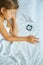 Little girl sleeping on a big and cozy bed white linen in the afternoon at home