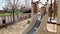 Little girl sliding on city children playground