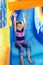 Little Girl sliding down an inflatable Slide