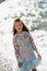 A little girl in a smart white dress walks along the embankment of lake Garda.A girl is photographed against the background of a