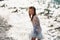 A little girl in a smart white dress walks along the embankment of lake Garda.A girl is photographed against the background of a