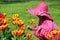 Little girl smell tulip flower