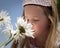 Little girl smelling flowers