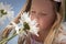 Little girl smelling flowers