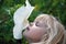 little girl smelling a hibiscus