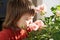 Little girl smelling spring flowers, kid feeling happiness,joyful people without spring allergy