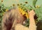 Little girl smelling sunflower - vintage retro style