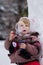 Little girl with soap bubles in winter