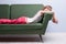 Little girl softly sleeping on a green sofa