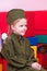 Little girl in the Soviet military uniform and cap