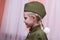 Little girl in the Soviet military uniform and cap