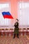 Little girl in Soviet military uniform waving flag