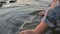 A little girl splashing sea water by the sea coast