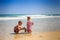 Little Girl in Spotty Boy Play on Edge of Wave Surf of Beach