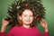 Little girl with spruce wreath