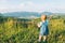 Little girl stand on the peak and looking on mountains