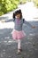 Little girl standing with arms raise one leg to practice balance.