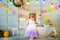 A little girl is standing in a decorated room