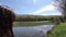 Little girl Standing At Edge Of Lake, Looking At View Of Forest and lake Panorama
