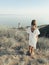 Little girl standing on hill against sea