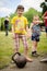 Little girl is standing near a kettlebell in amateur competitions