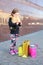 Little girl standing with pink phone and shopping