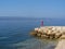 Little girl standing on the rocks watching the sea