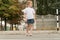 little girl stands on a pedestrian crossing. the child crosses the road on a zebra