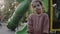 Little girl stands on the playground looking around. Family, child and healthy lifestyle concept.