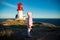 Little girl stands on rocky northern seashore