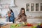 Little girl stirring vegetable salad a big spoon.