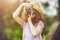 Little girl in straw hat, rustic style dress with retro photo ca