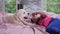 Little girl stroking puppy lying on bed in nursery