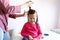 Little girl suffering while getting hair done
