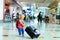 Little girl with suitcase travel in the airport