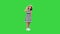 Little girl in summer outfit walking by, making a stop to wave to camera on a Green Screen, Chroma Key.