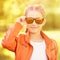 Little girl with sun eyeglasses. Bright dress.