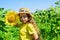 Little girl sunflowers field blue sky background, childhood at village