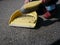 Little girl sweeps dirt street in paddle