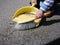 Little girl sweeps dirt street in paddle