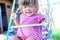 Little girl swing outdoor , toddler having fun on playground, children playing