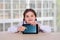 Little girl with a tablet. Communication, school education, games of a child, a teenager with a modern device. interactive social