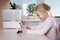 Little girl with tablet pc sitting near humidifier and smiling