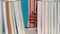 Little girl taking books off a bookshelf and peeking through