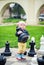 Little girl taking a chessman