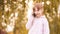 Little girl talk phone. Autumn background