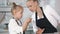 Little girl talking with her mother which cooking cottage cheese pancakes in the kitchen