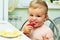 Little girl tasting strawberry